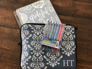 Erin Condren planner, carry case, and Frixion pens.